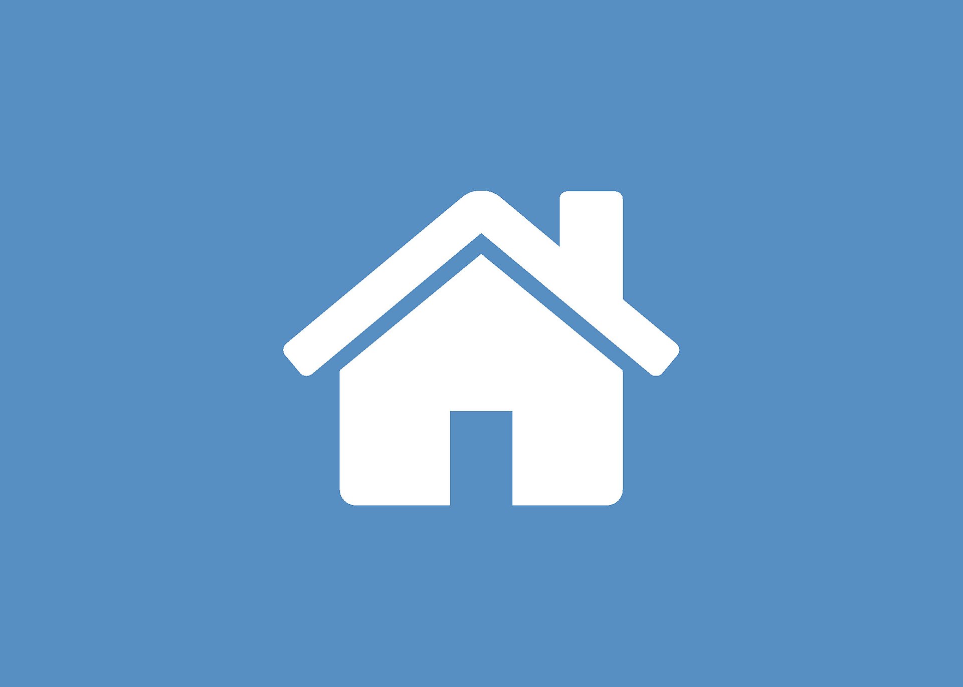 En ikon på ett vitt hus i mitten av bilden med blå bakgrund.